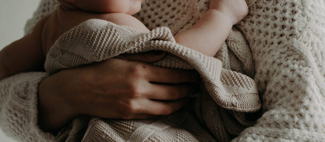 Canva - Woman Carrying A Baby